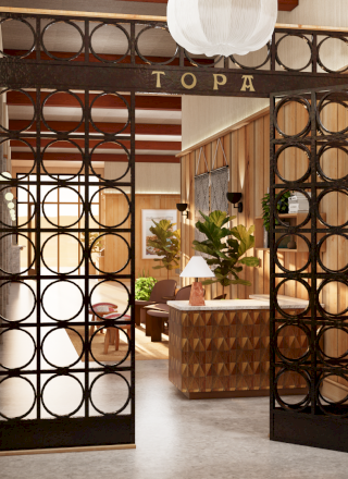 A cozy bookstore or library with warm lighting, wooden shelves full of books, and a welcoming, organized corner.